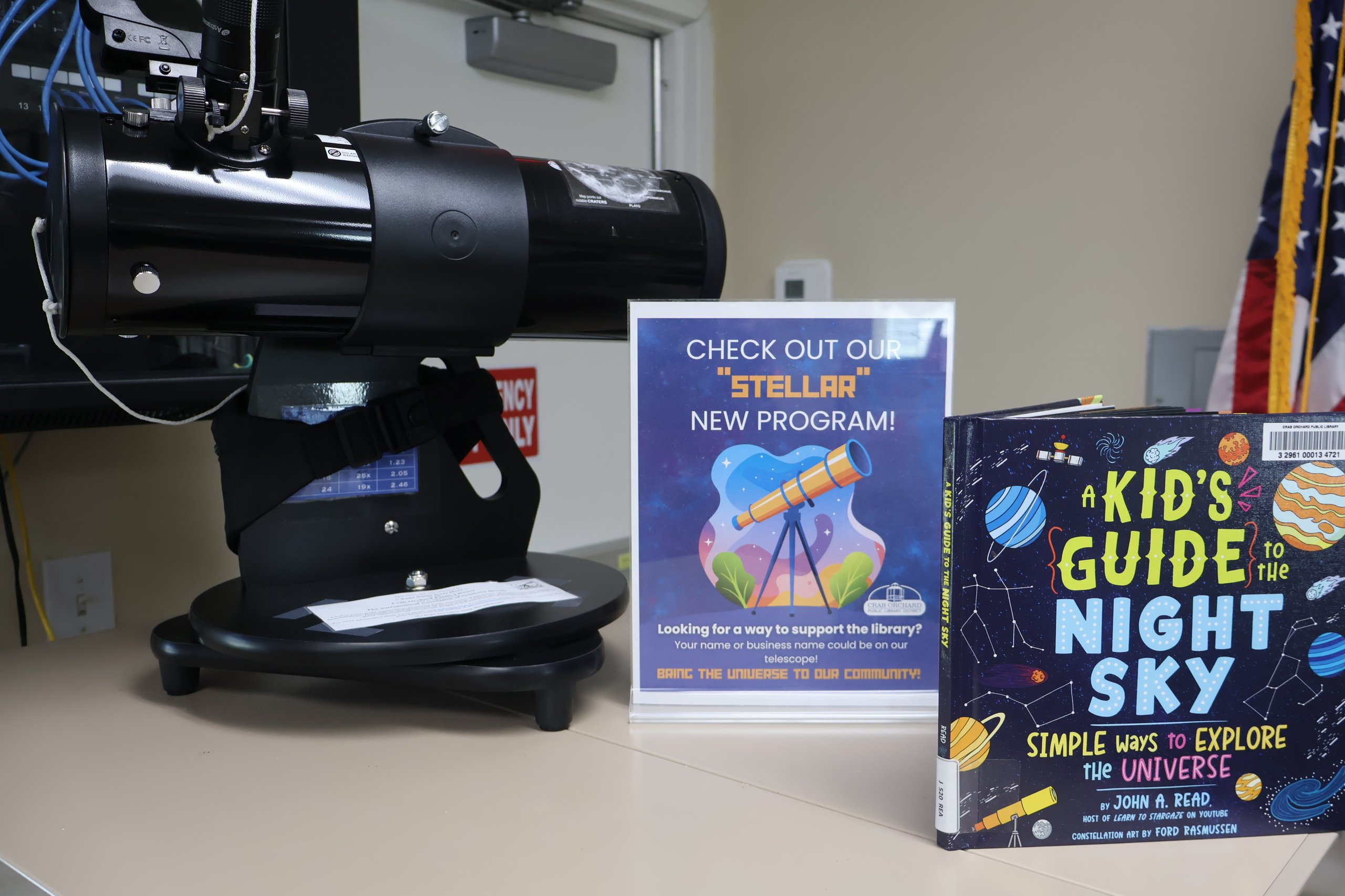 Telescope and books on the night sky at Crab Orchard Library